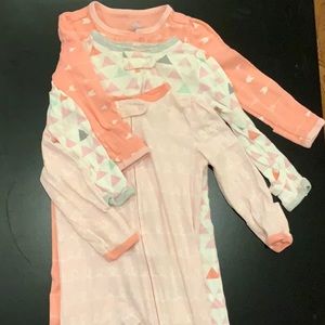 Set of three long sleeve footed onesie.